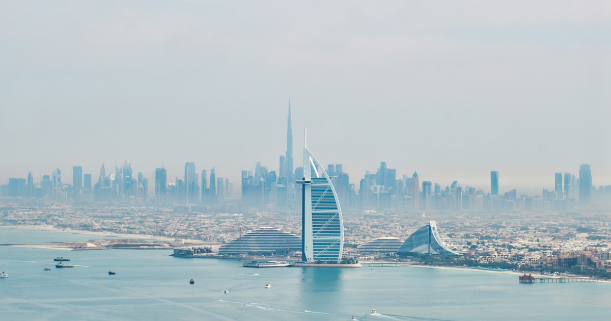 a large body of water with a city in the background